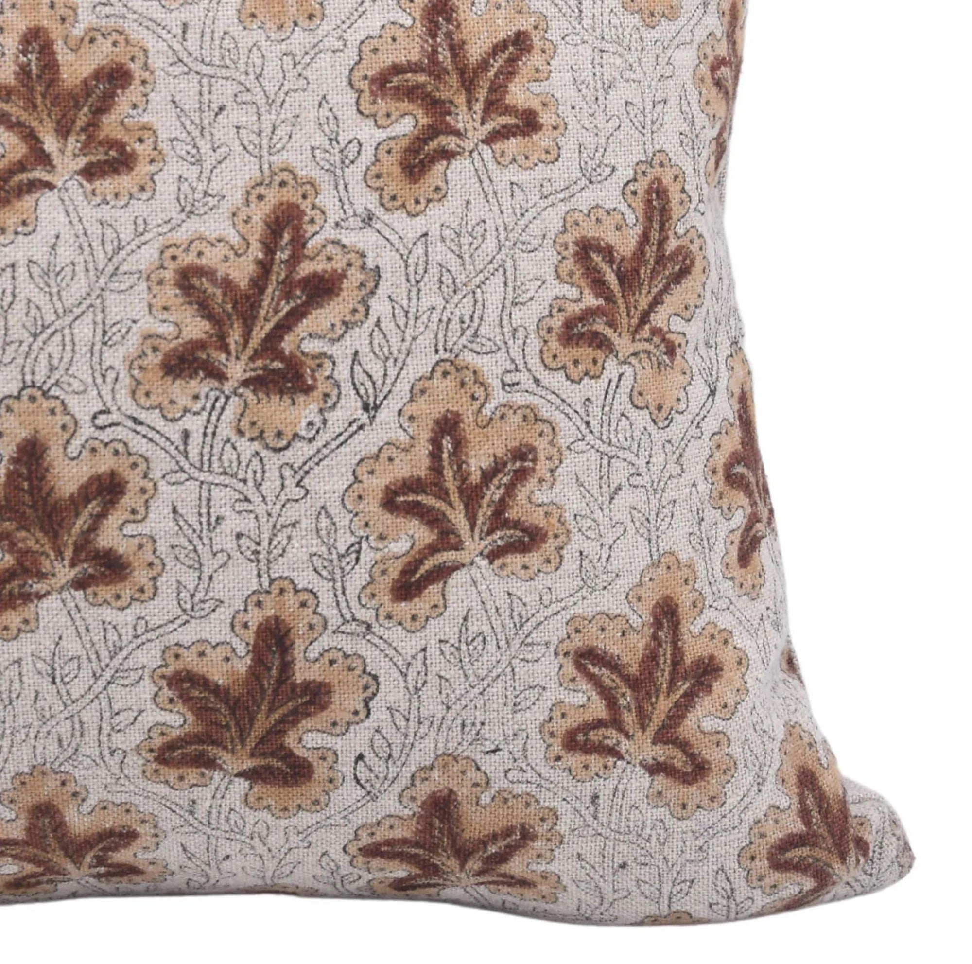Decorative pillow with brown leaf pattern on a white background