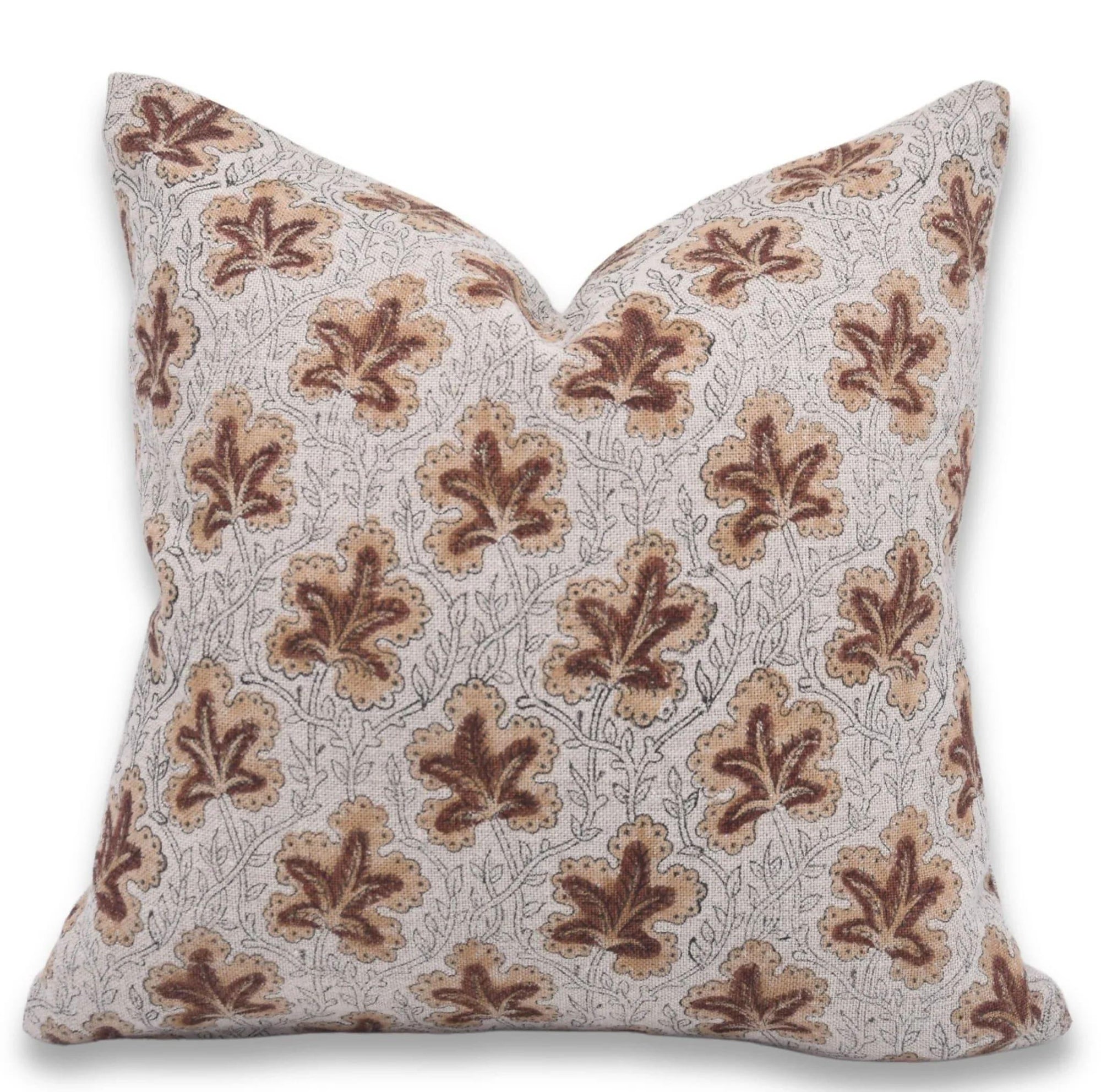 Decorative pillow with brown leaf pattern on a white background
