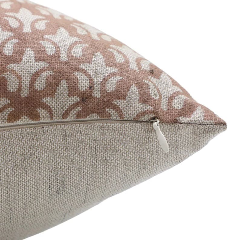 Close-up of a decorative pillow with a floral pattern on a white background