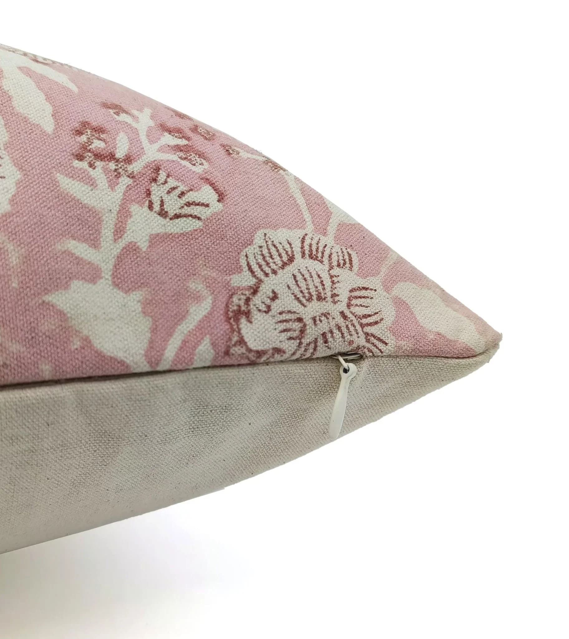 Floral patterned pillow with a plain base on a white background