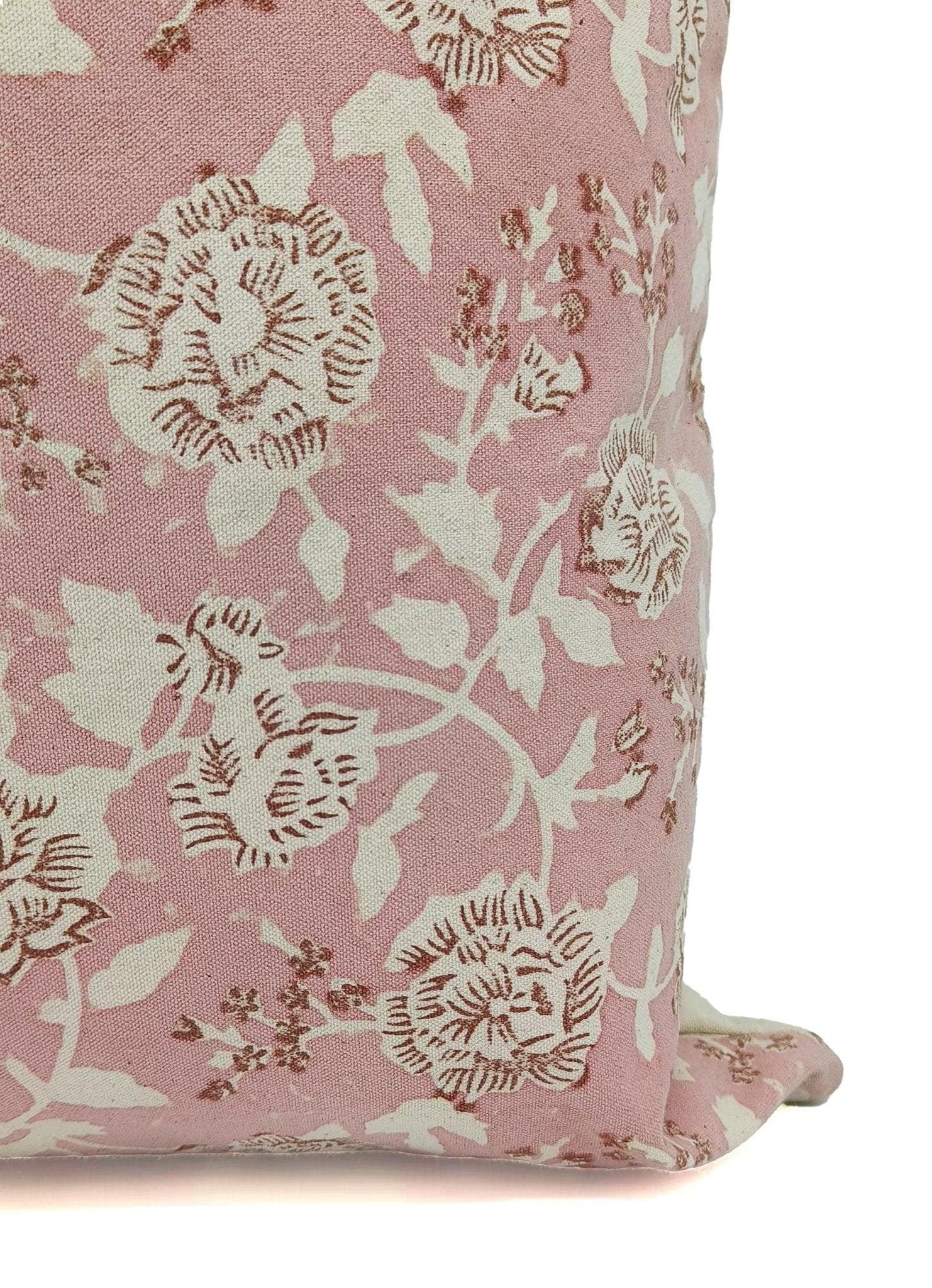 Floral patterned pillow on a pink background