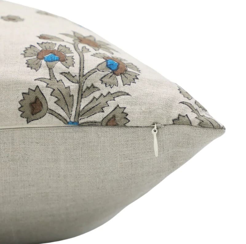Decorative pillow with floral embroidery on a beige background

