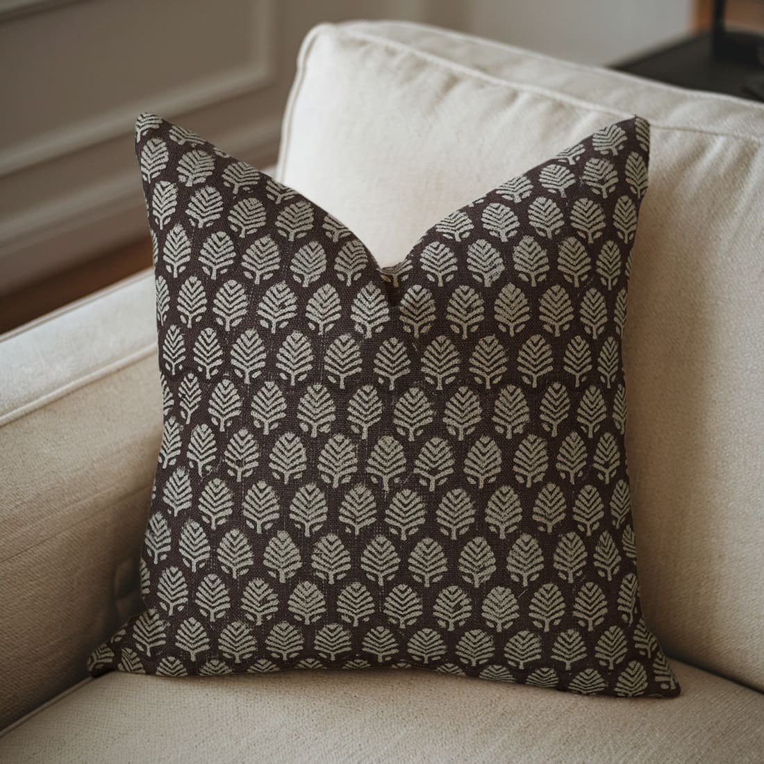 Hand block printed cushion cover displayed on sofa