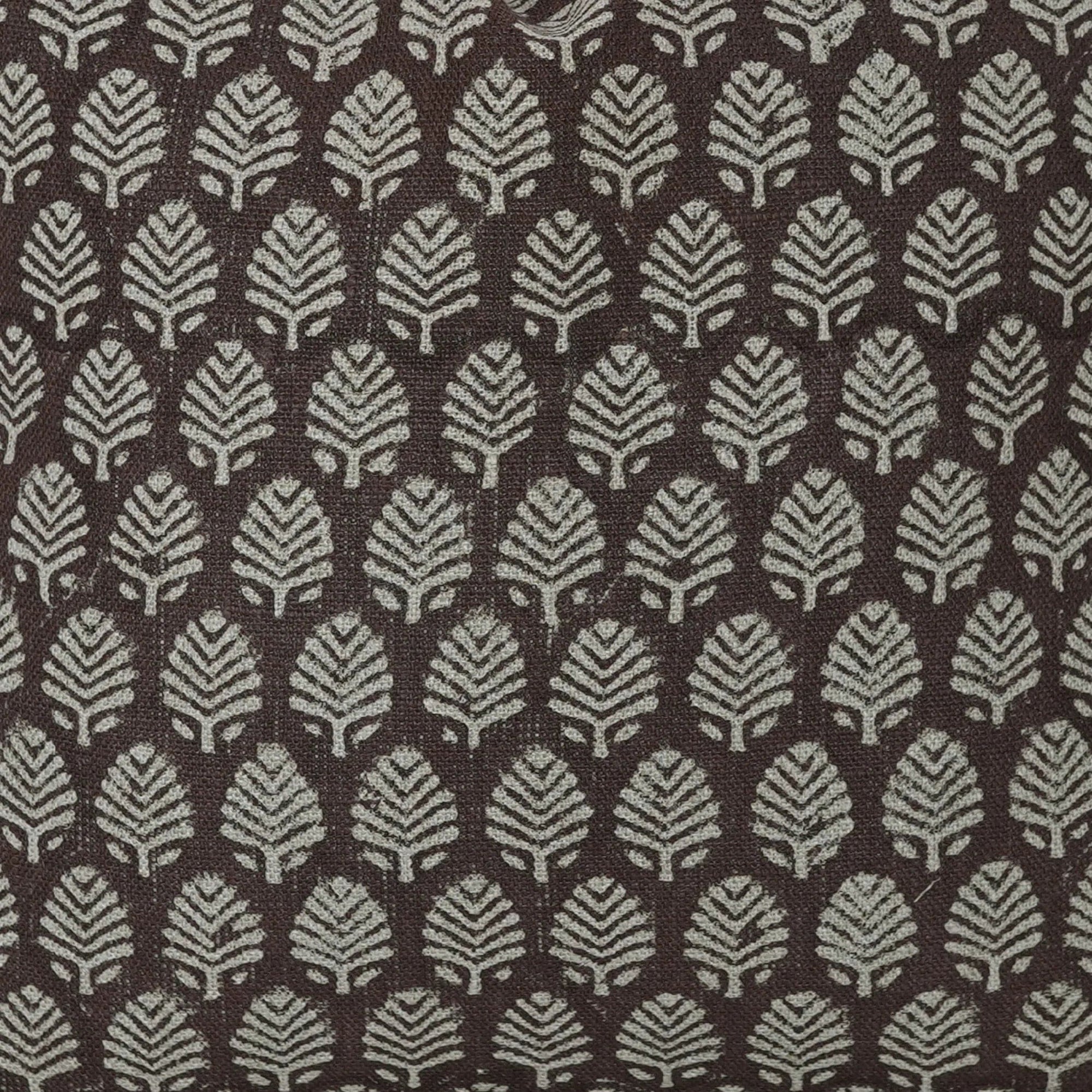 Patterned fabric with leaf design on a brown background