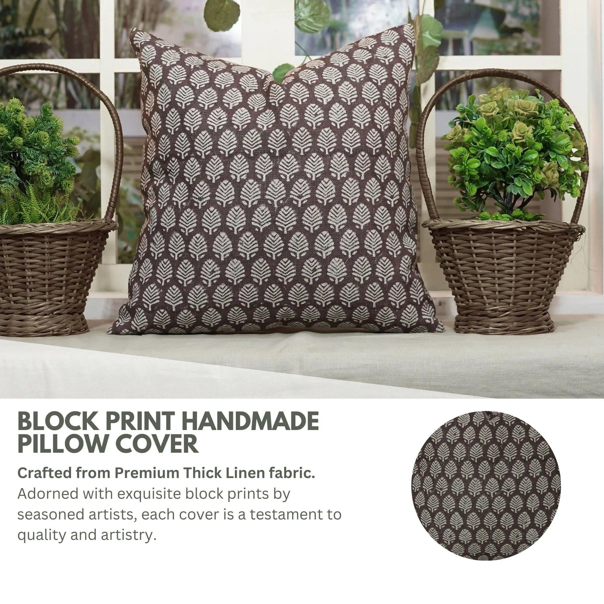 Block print handmade pillow cover with leaf pattern on a bench with plants