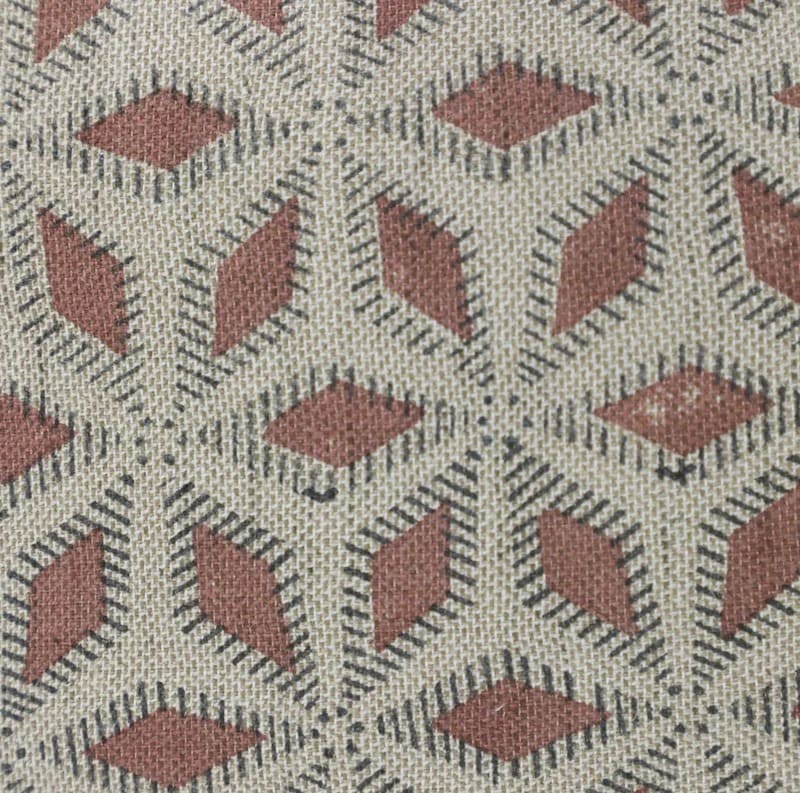 Textile pattern with red and black geometric shapes on a beige background

