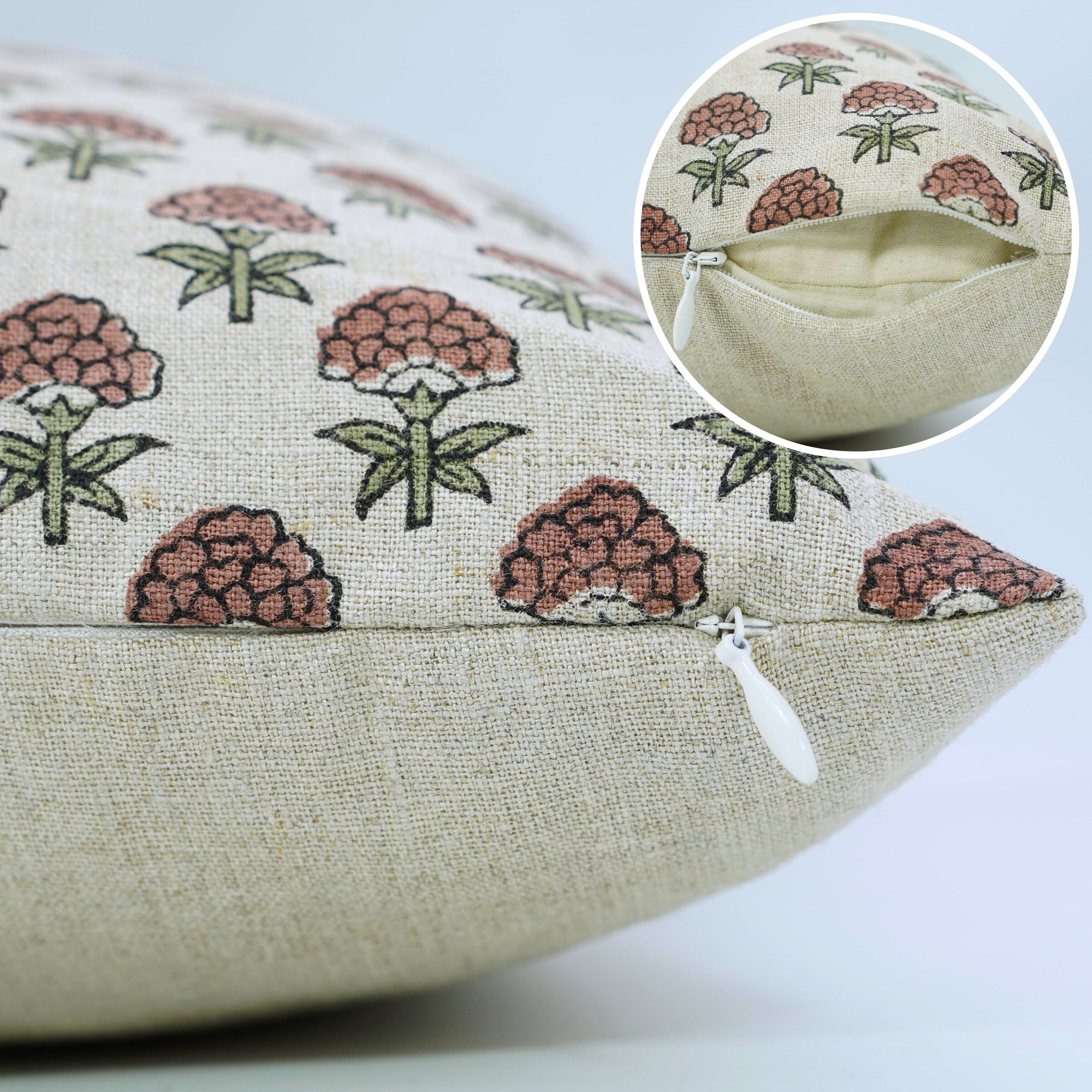 Decorative pillow with floral pattern and close-up of stitching 