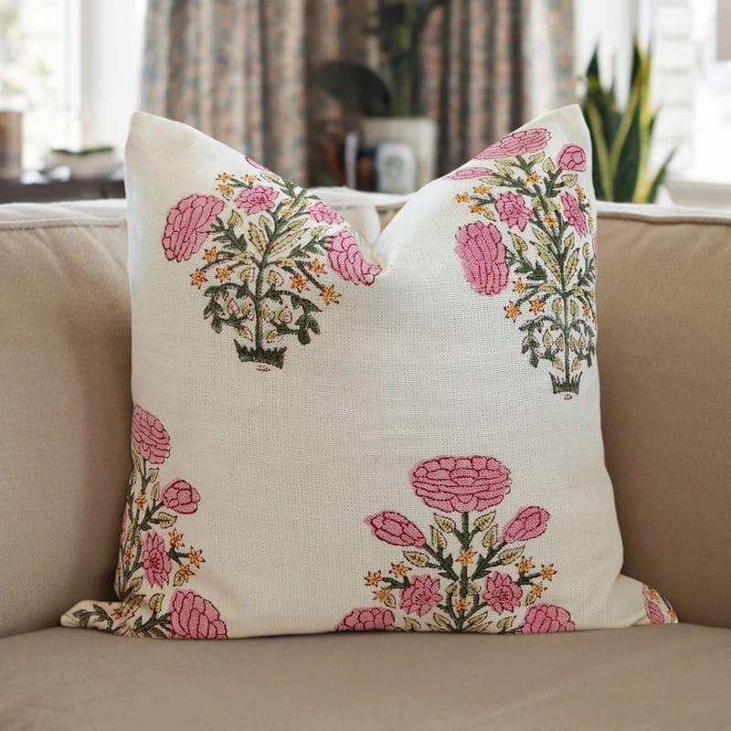 Decorative pillow with floral patterns on a beige couch