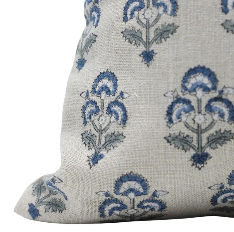 Decorative pillow with blue floral pattern on a light background
