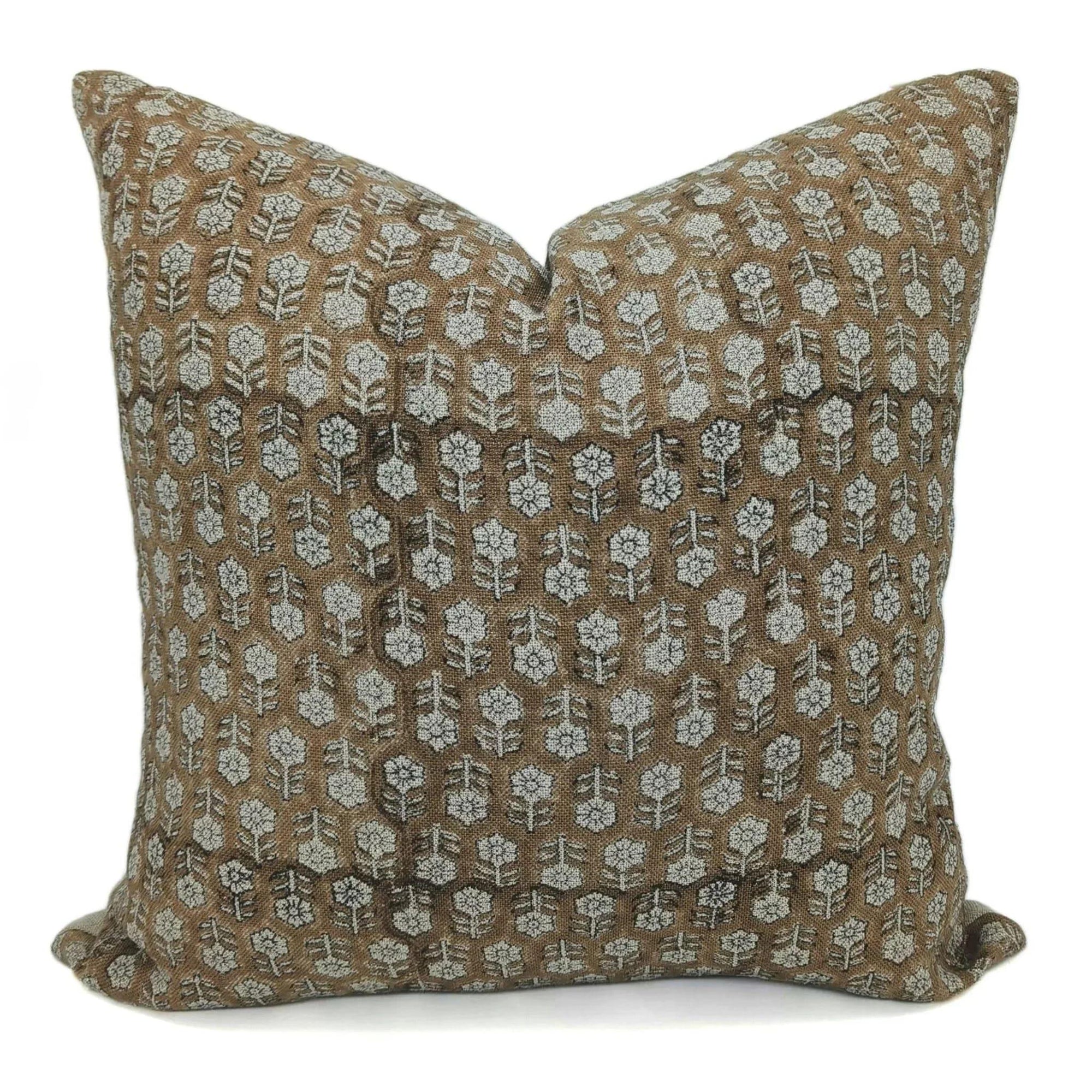 Decorative pillow with floral pattern on brown fabric