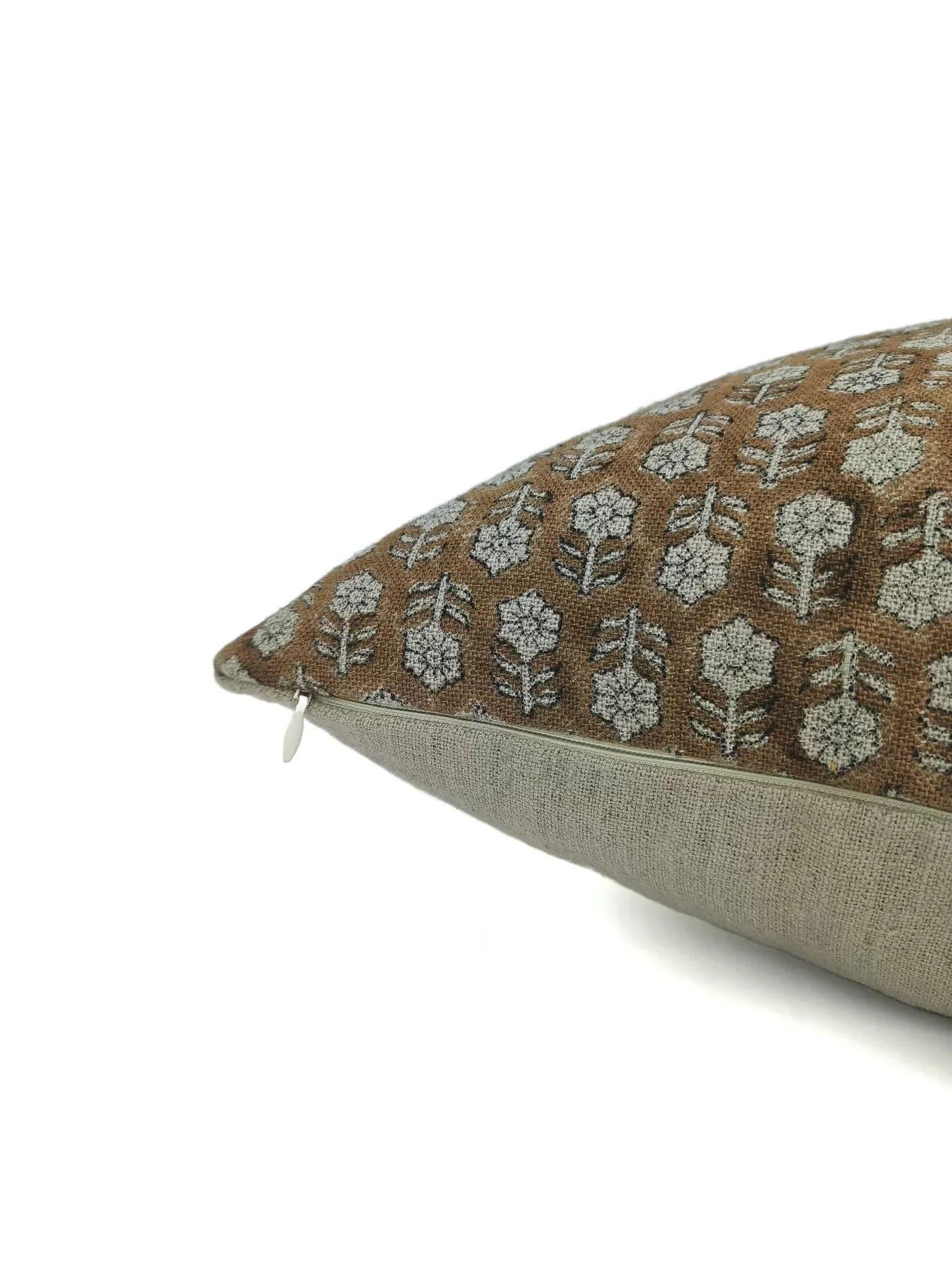 Decorative pillow with floral pattern on brown and beige fabric