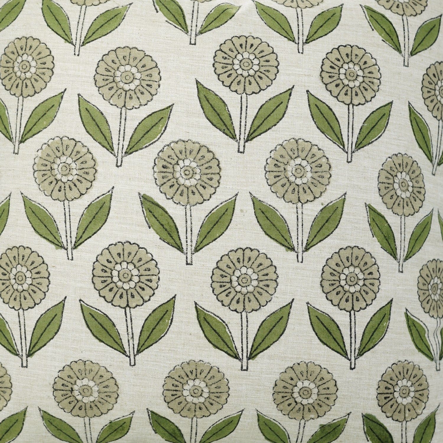Beige fabric featuring green floral and leaf design created with traditional handblock print