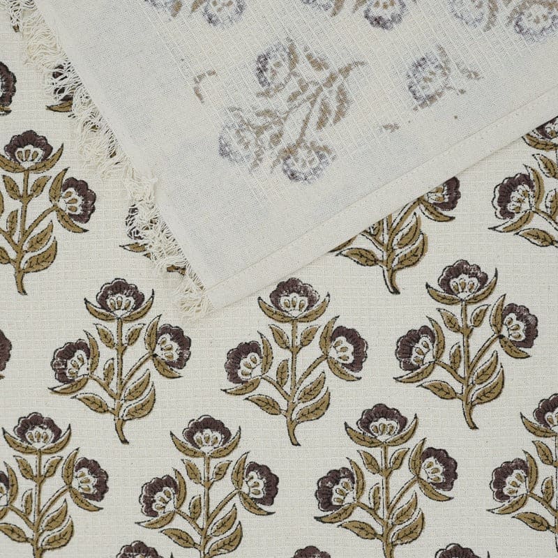 Green patterned hand towel on shelf