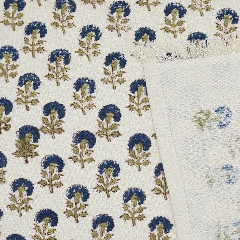 Decorative green towel folded on kitchen counter