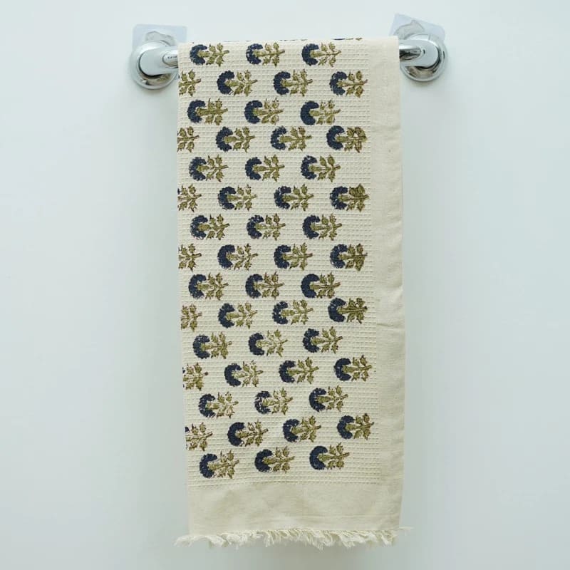 Hand towel green design on bathroom shelf