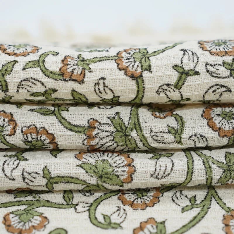 Green patterned towel draped over hook