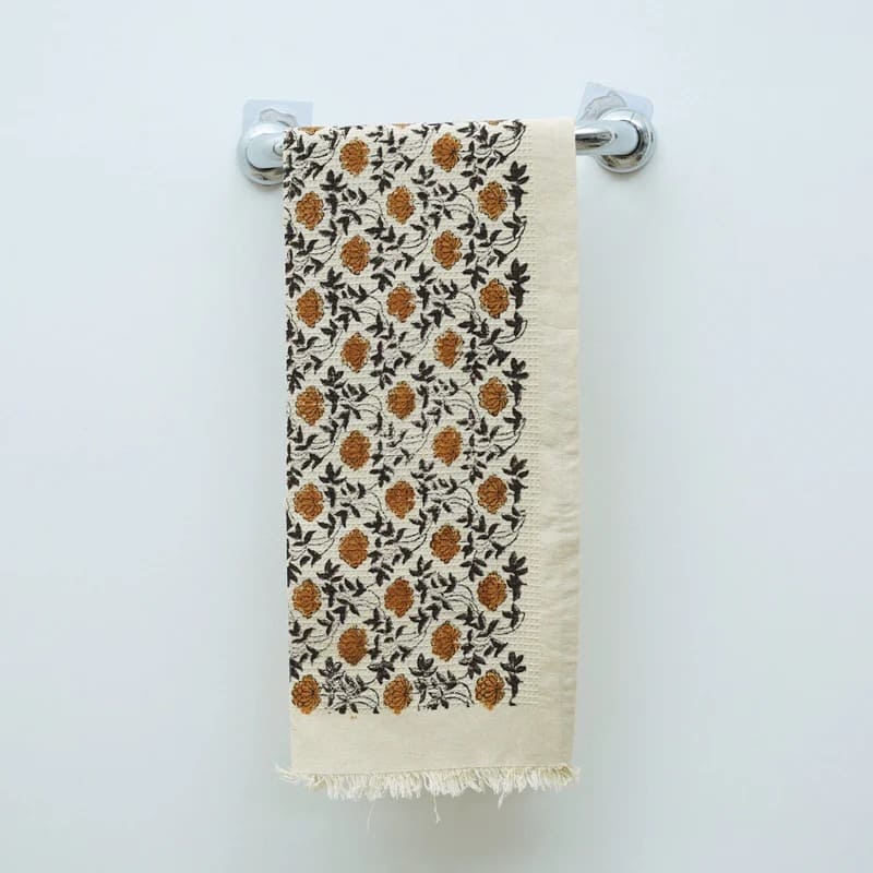 Soft green hand towel draped over countertop