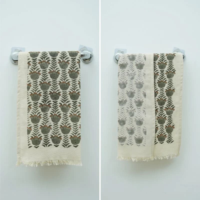 Hand towel green patterned resting on shelf