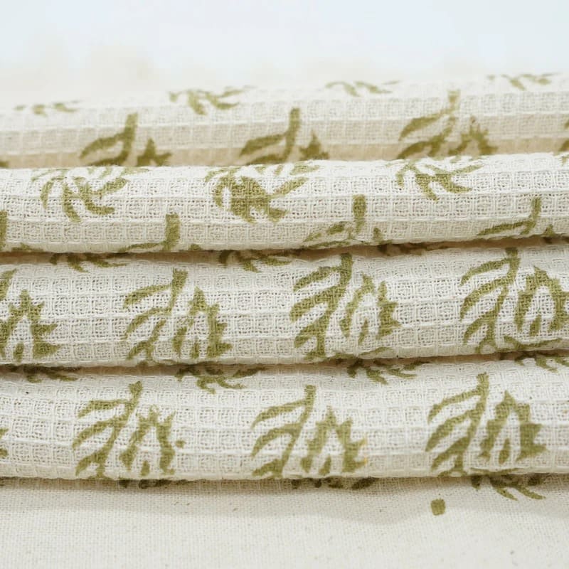 Green patterned towel hanging over rail