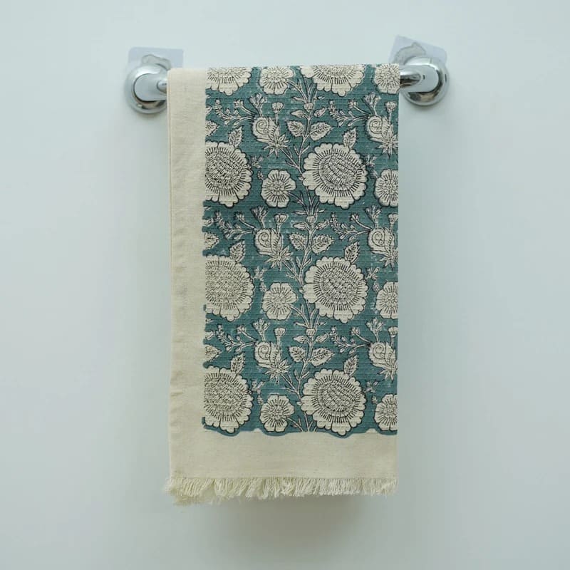 Green patterned tea towel with floral artwork