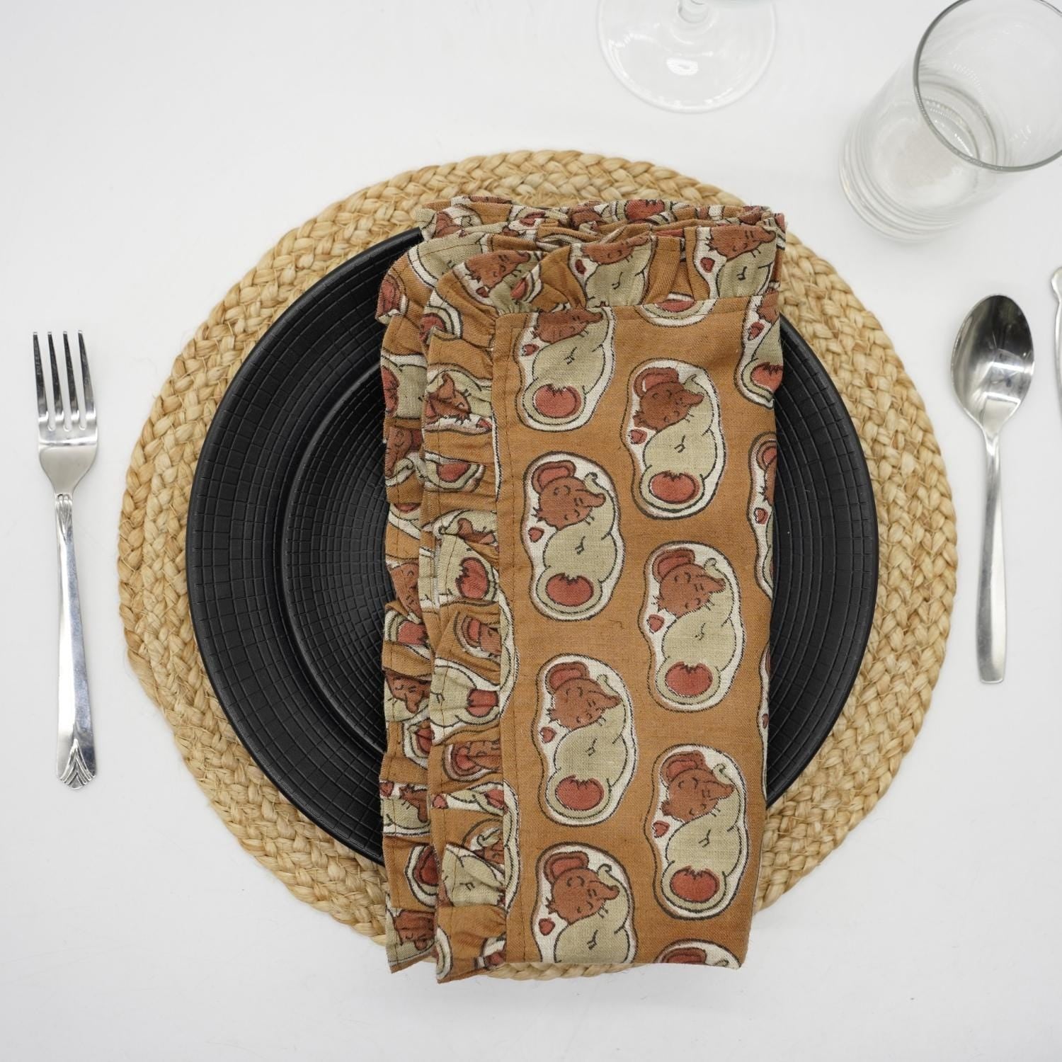 Beige elephant block print frill napkin on a cozy dining table.