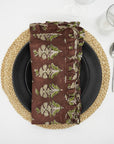 Brown block print frill napkin on an elegant dining table.