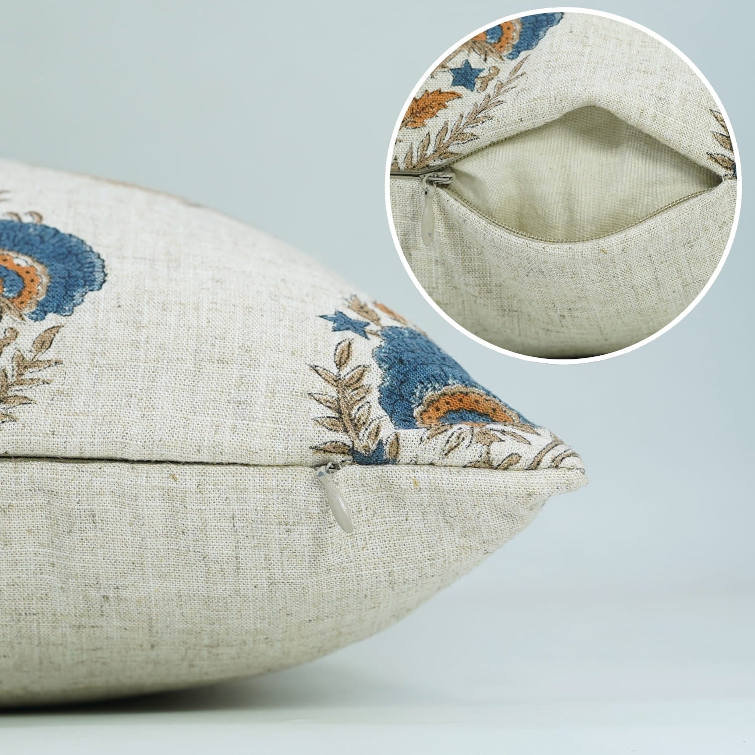 Decorative pillow with floral embroidery and close-up of stitching on a light gray background