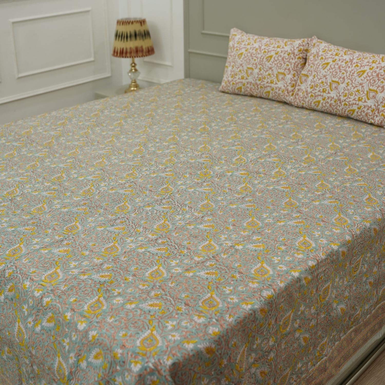 Brighten your space with this hand block printed floral cotton bedsheet and pillow set. The natural texture and handmade details make it a perfect choice for farmhouse or bohemian bedrooms.