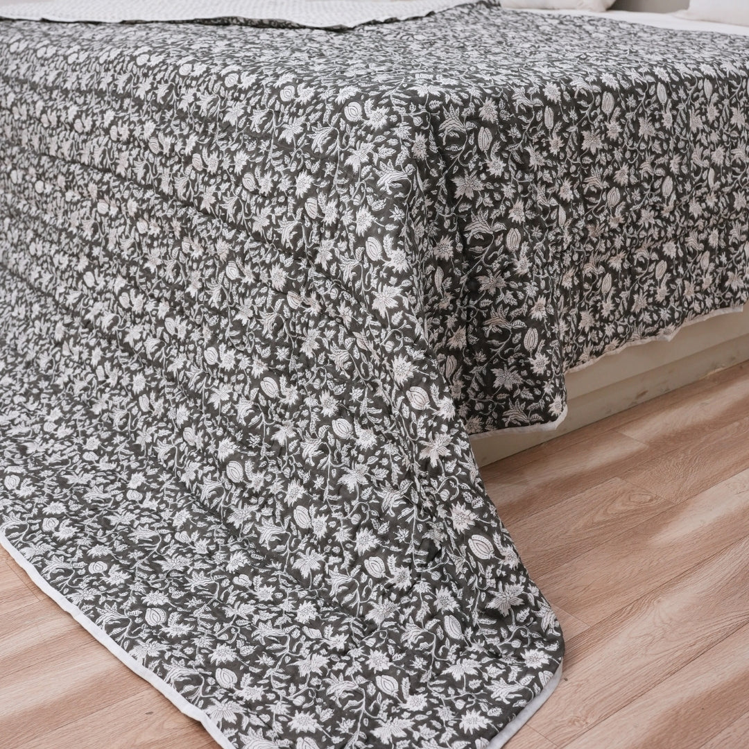 Floral patterned quilt  on a bed