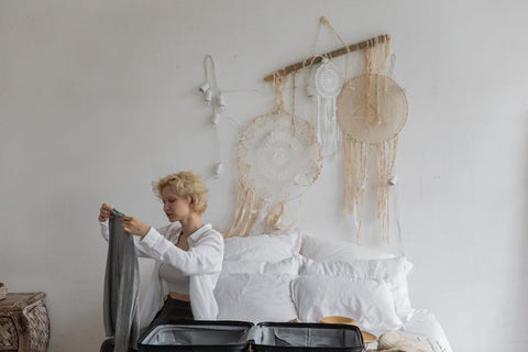 Woman examining gray fabric, showcasing boho home accessories for aesthetic decor.