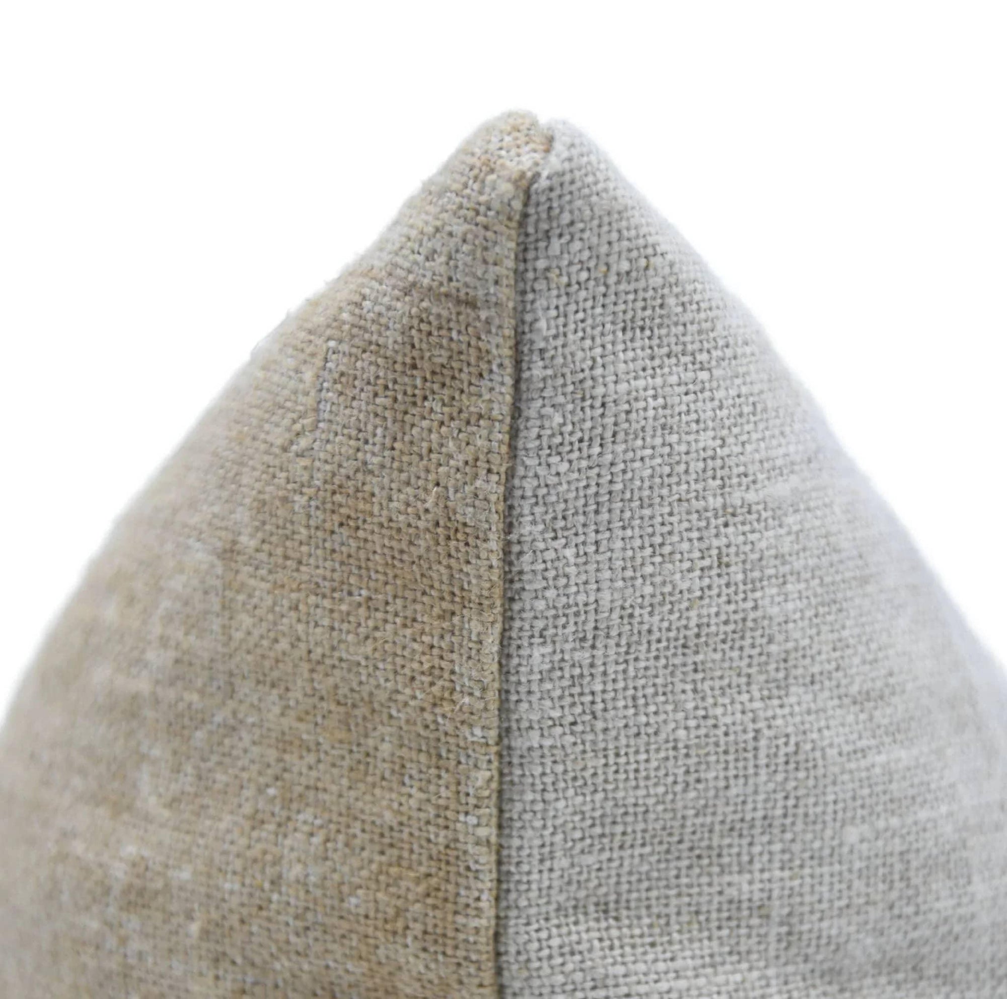 Textured fabric triangle with two colors showing knife edges of pillow