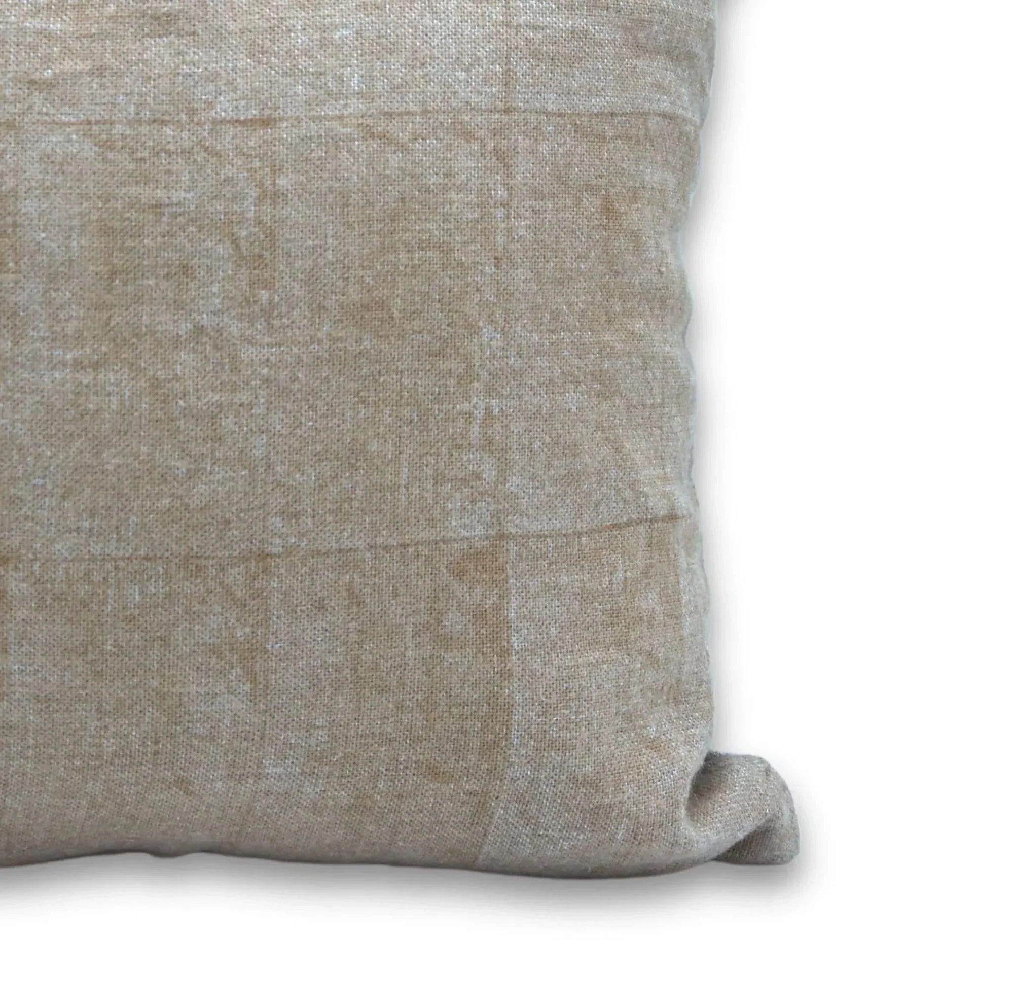 Close-up of a textured beige pillow on a white background